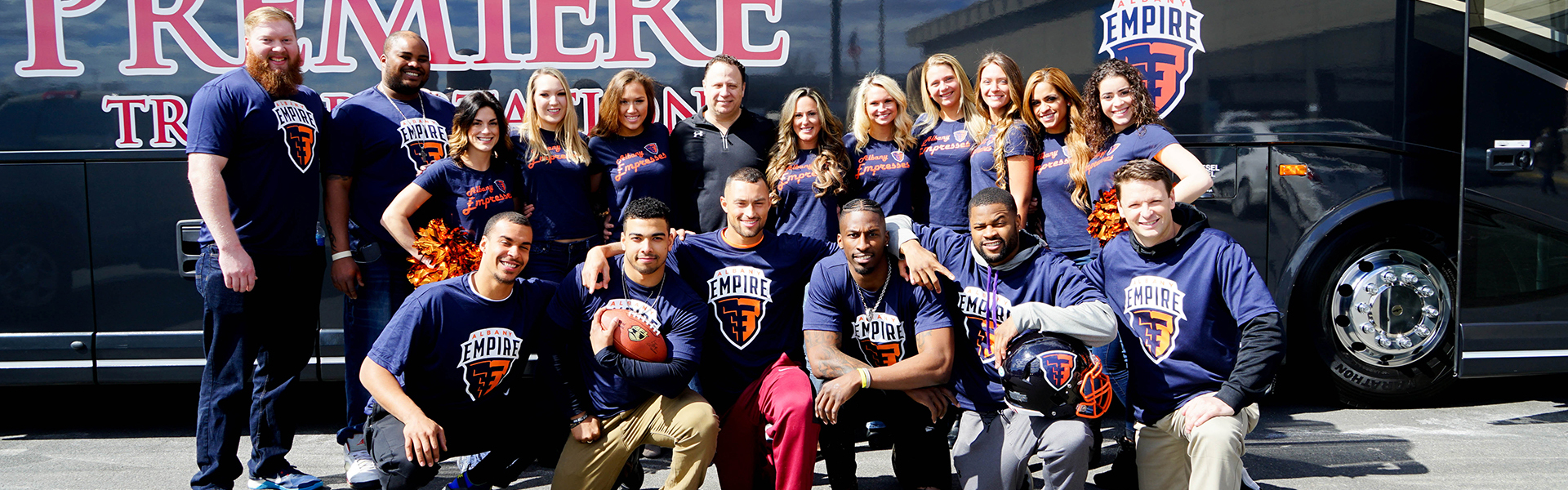 Albany Empire team in front of Premiere bus